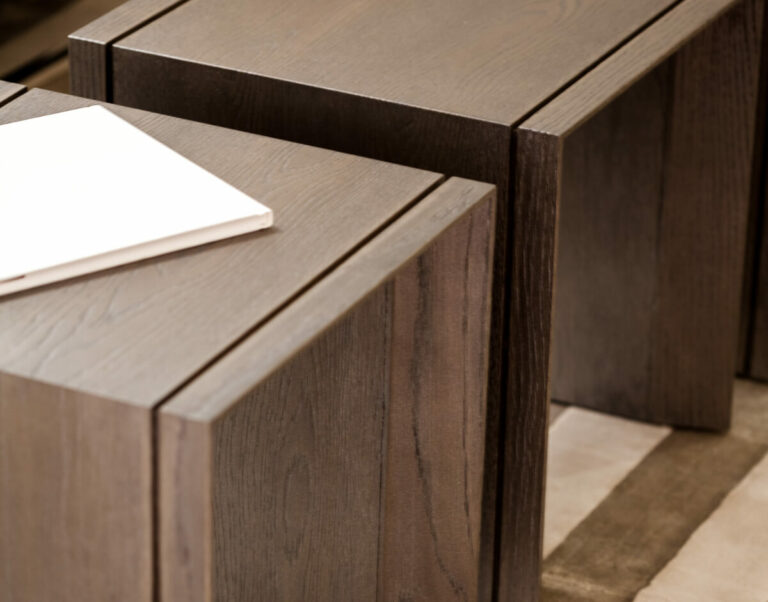 Dark brown Vienna End Table nesting with a white book on top for stylish living space