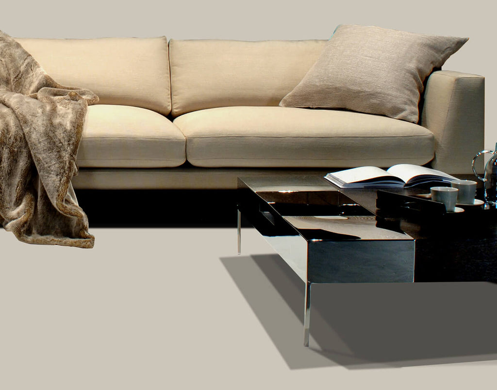 Paris Sofa in cream with plush throw pillow and black coffee table with books