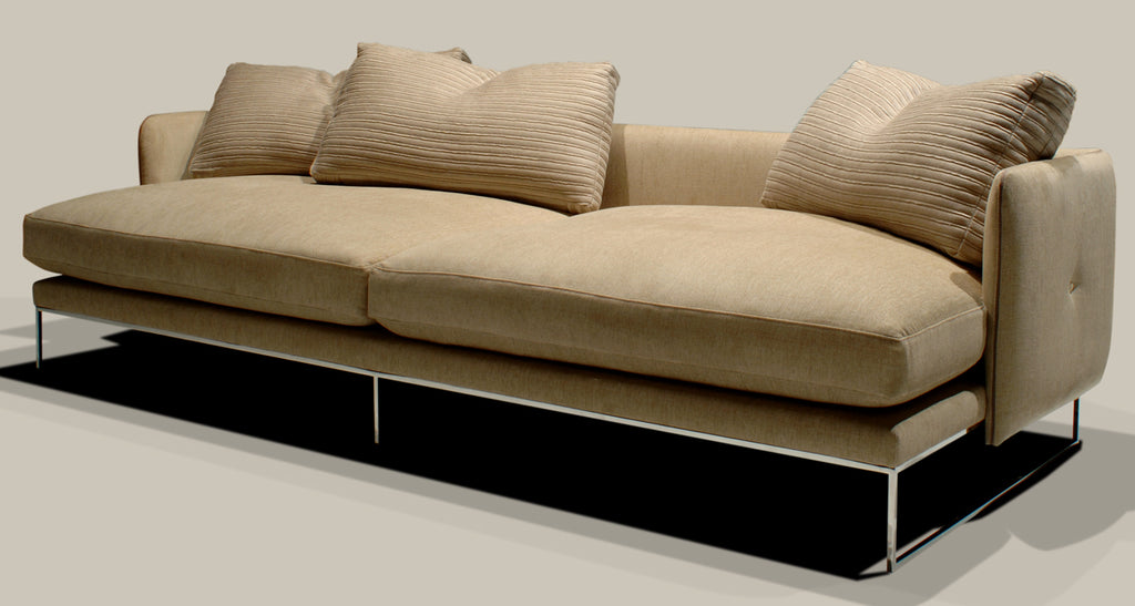Paris Sofa featuring a long light beige design with slim metal legs and plush cushions