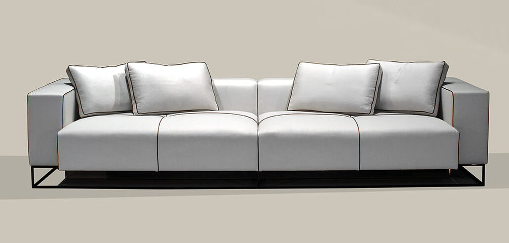 Modern light gray Glasgow Sofa with black piping and metal base for stylish living rooms