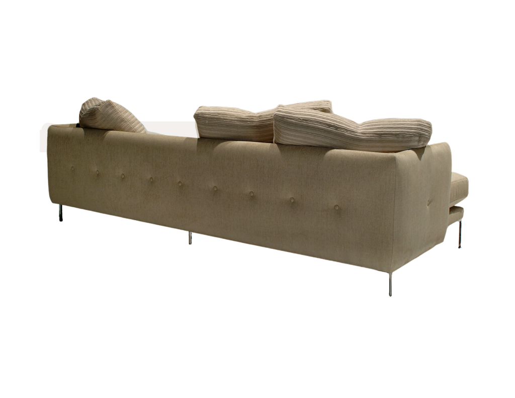 Light-colored tufted leather Paris Sofa with striped cushions and metal legs
