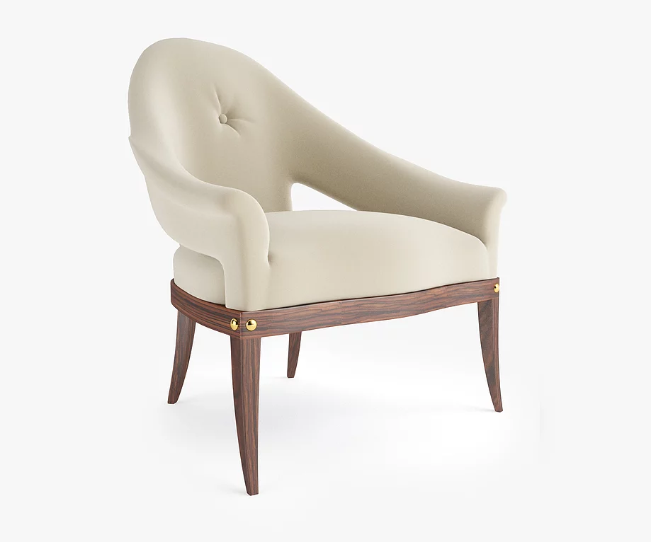 Cream-colored upholstered Avalon Chair with tufted back, curved design, and gold accents