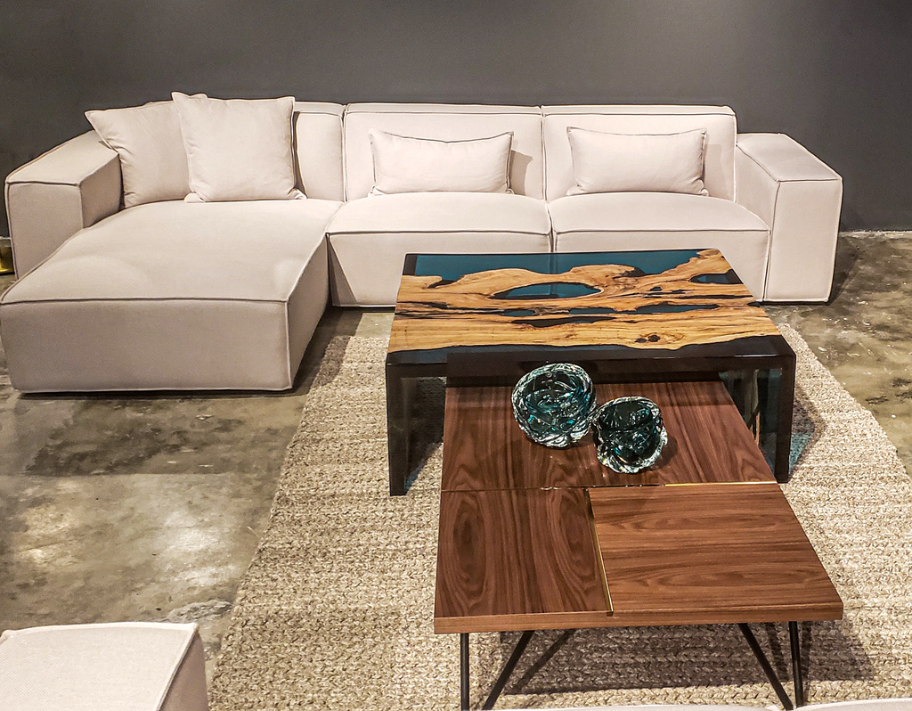 Modern L-shaped sectional sofa with throw pillows, complementing the Blue Waterfall Olive Coffee Table