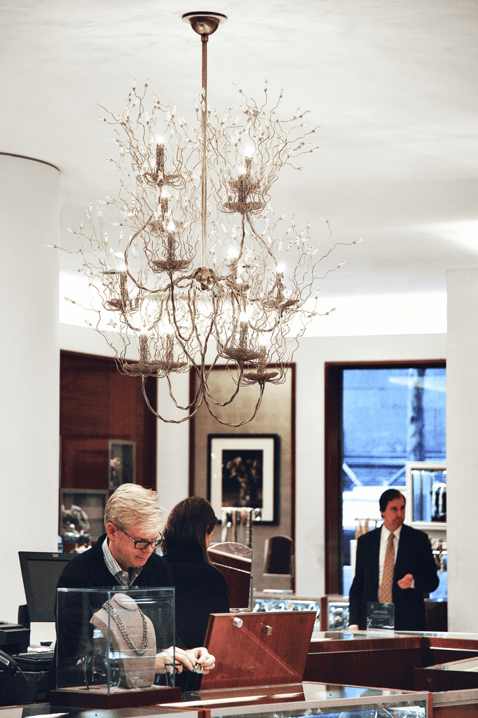 Ornate spirits chandelier round with multi-tiered design and candle-like light sources