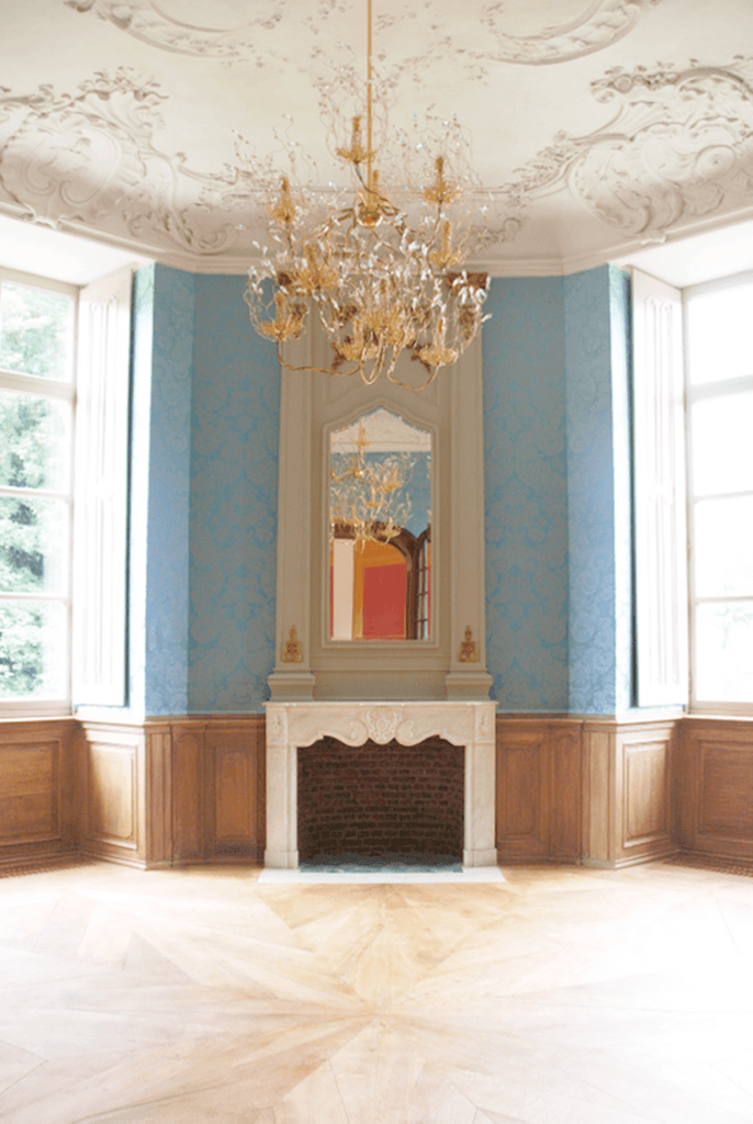 Elegant grand empty room with a spirits chandelier round and fireplace for sophisticated decor