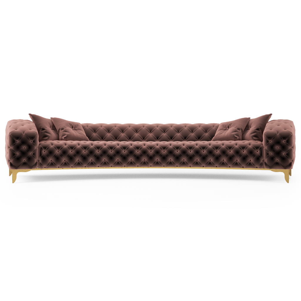 Luxury mauve velvet curved sofa with tufted design, gold legs, and matching pillows