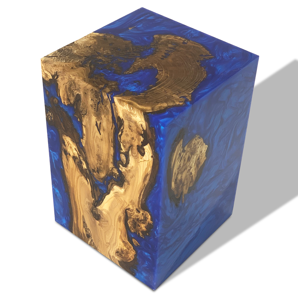 Dione Pearl Blue end table featuring a clear blue resin block encasing natural wood burl