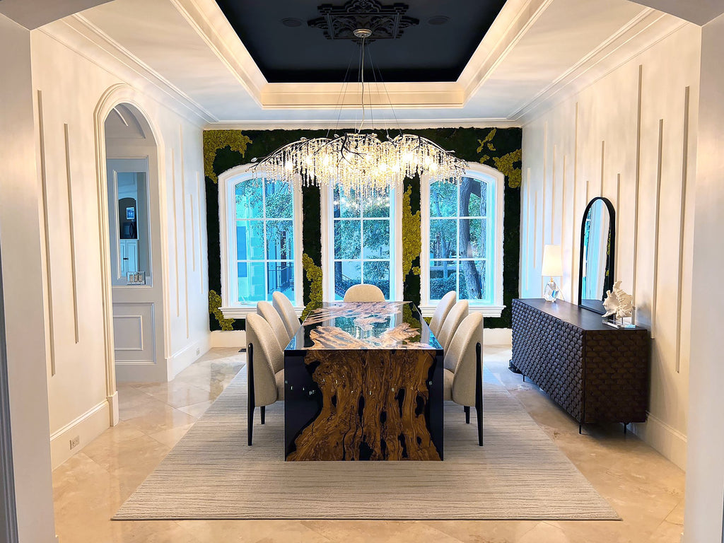 Modern olive wood dining table with resin accents, upholstered chairs, and crystal chandelier