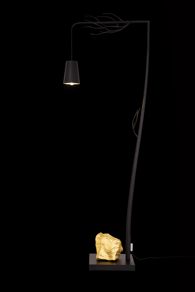 Flintstone Floor Lamp with black hanging shade and decorative golden rock base
