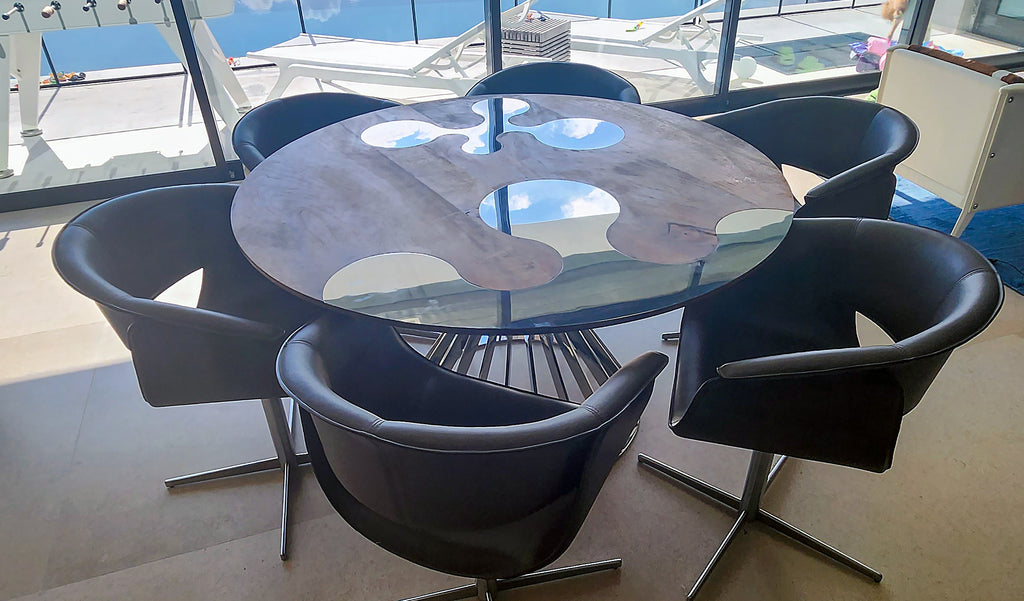 Amiata stainless steel walnut round dining table with glass top and six upholstered chairs