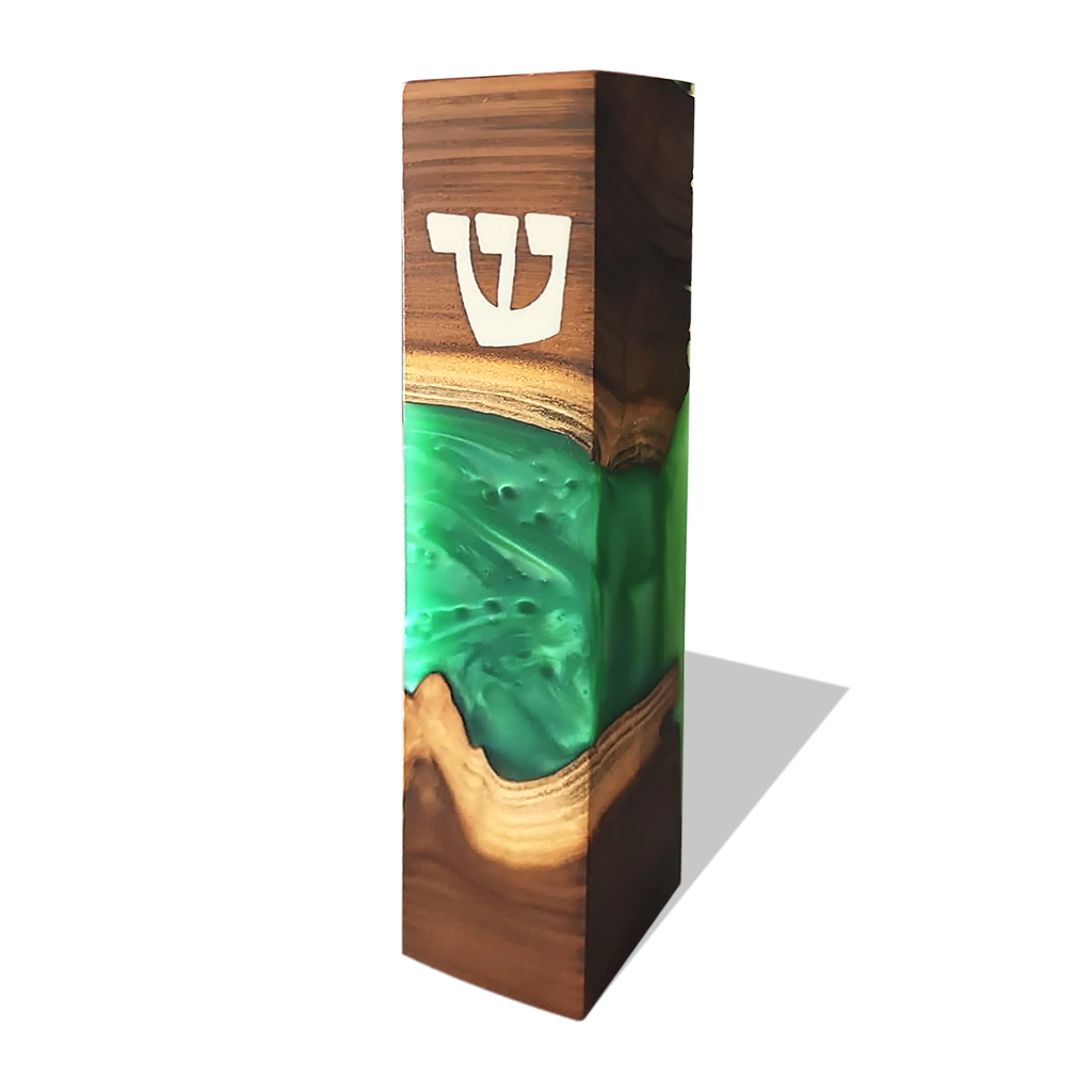 Modern mezuzah case in dark wood with green resin inlay and white Hebrew Shin