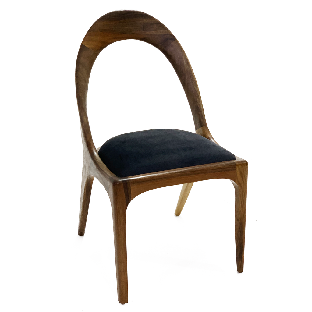 Nyks Dining Chair with wooden frame, curved backrest, and dark upholstered seat