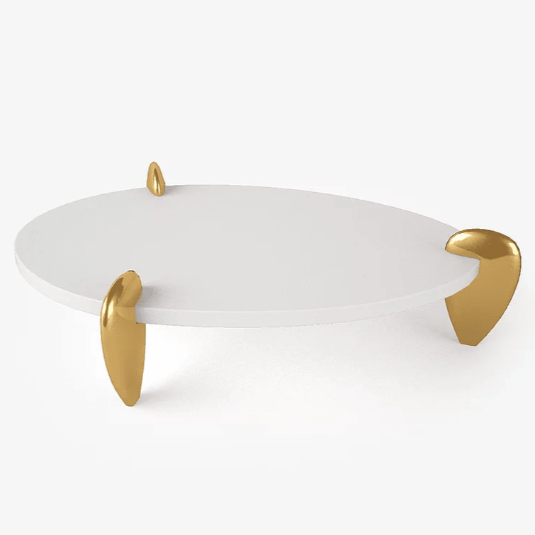 Remedy Cocktail Table with white oval top and three golden organically shaped legs