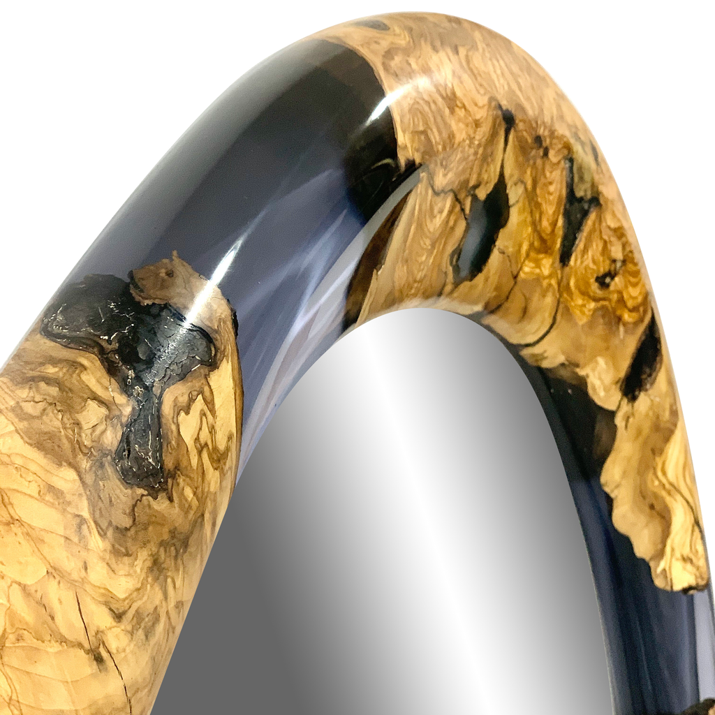 Polished curved wood and black resin detail of Rose Quartz Lotis Floor Mirror