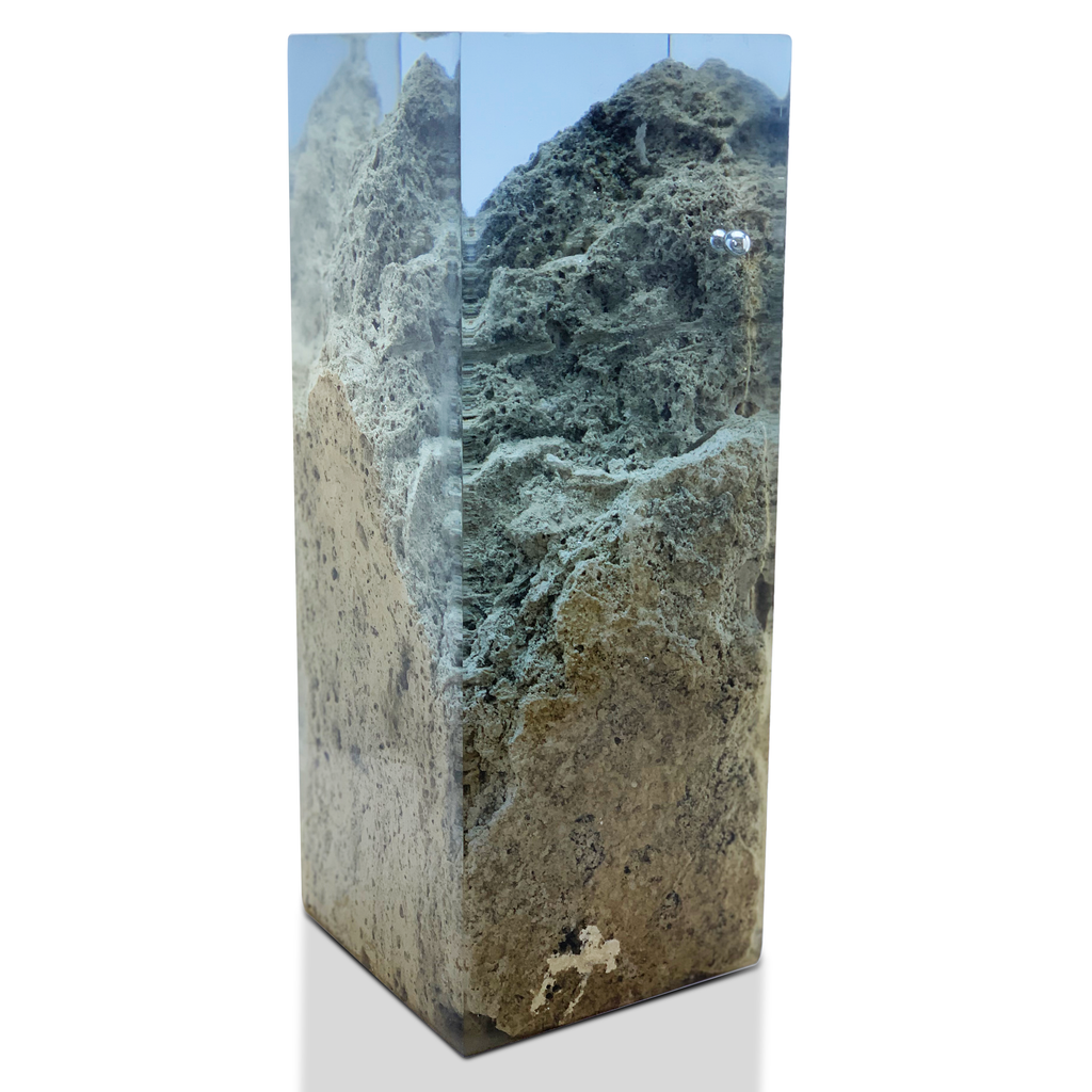 Clear resin encasing textured travertine rock decorative cube for unique rock decorative display